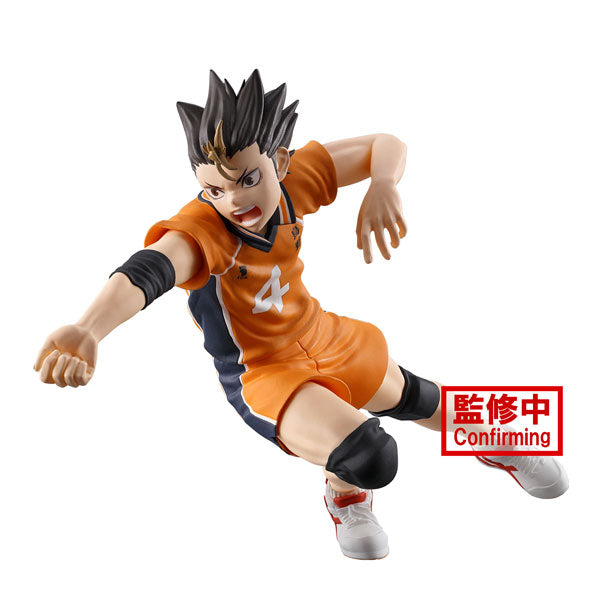 A figurine of Yu Nishinoya from Haikyu!!, dressed in an orange sports uniform and knee pads, captured mid-action with a determined expression. The character features spiky black hair and is posed dynamically. A red label with text is positioned near the bottom. This product is brought to you by Bandai.